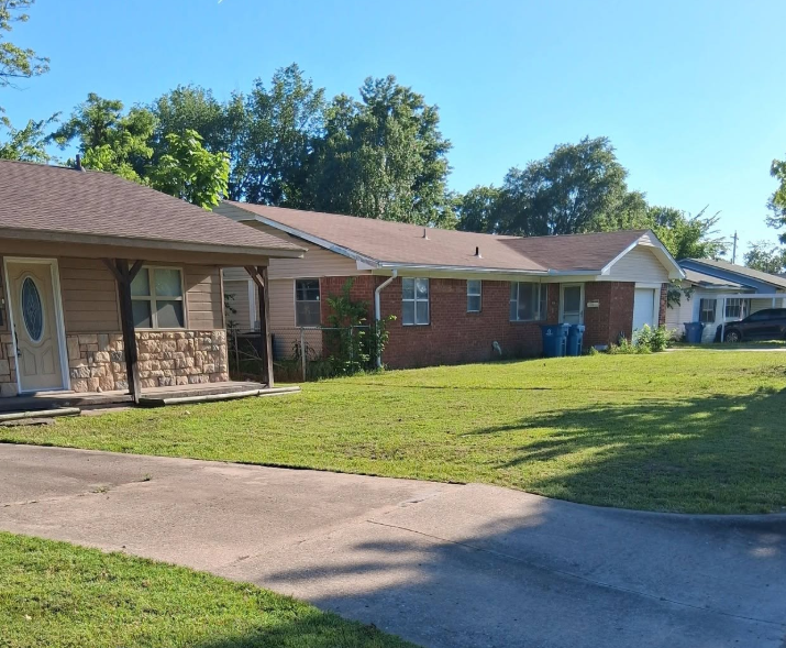 Neighborhood front lawns mowed and edged along a shared concrete driveway