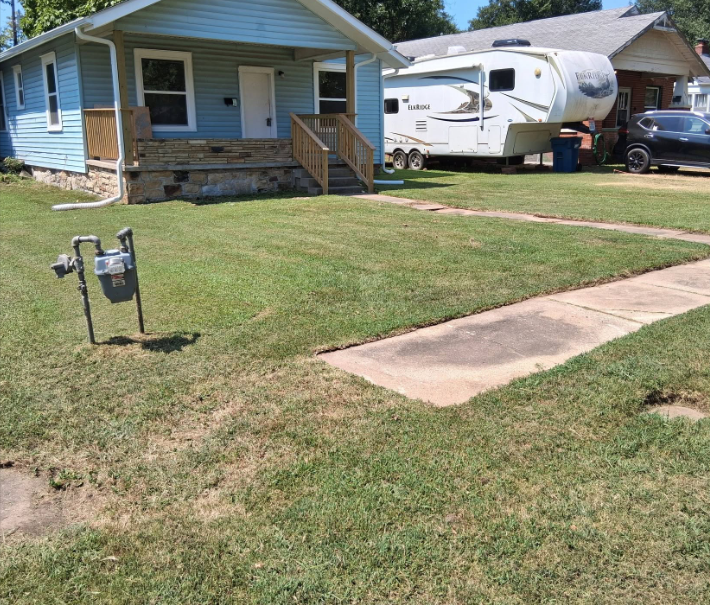 Freshly mowed front lawn with an edged sidewalk after service